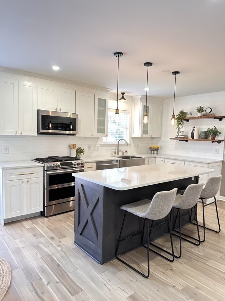400 Roma Court Nashville, TN 37211 - Photo 9 of 31 a kitchen with stainless steel appliances kitchen island granite countertop a stove a sink dishwasher and a microwave with wooden floor
