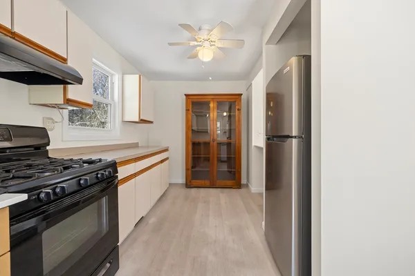 a kitchen with stainless steel appliances a stove and a refrigerator