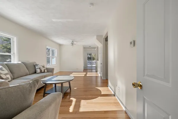 a living room with furniture and wooden floor