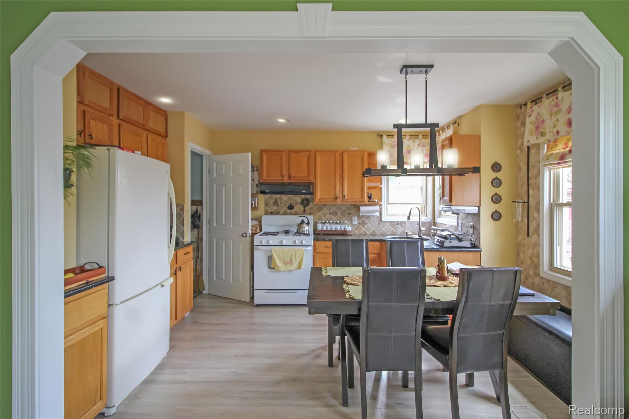 5953 Cooper Street Taylor, MI 48180 - Photo 12 of 33 Light wood-finish flooring extending through the kitchen and dining areas