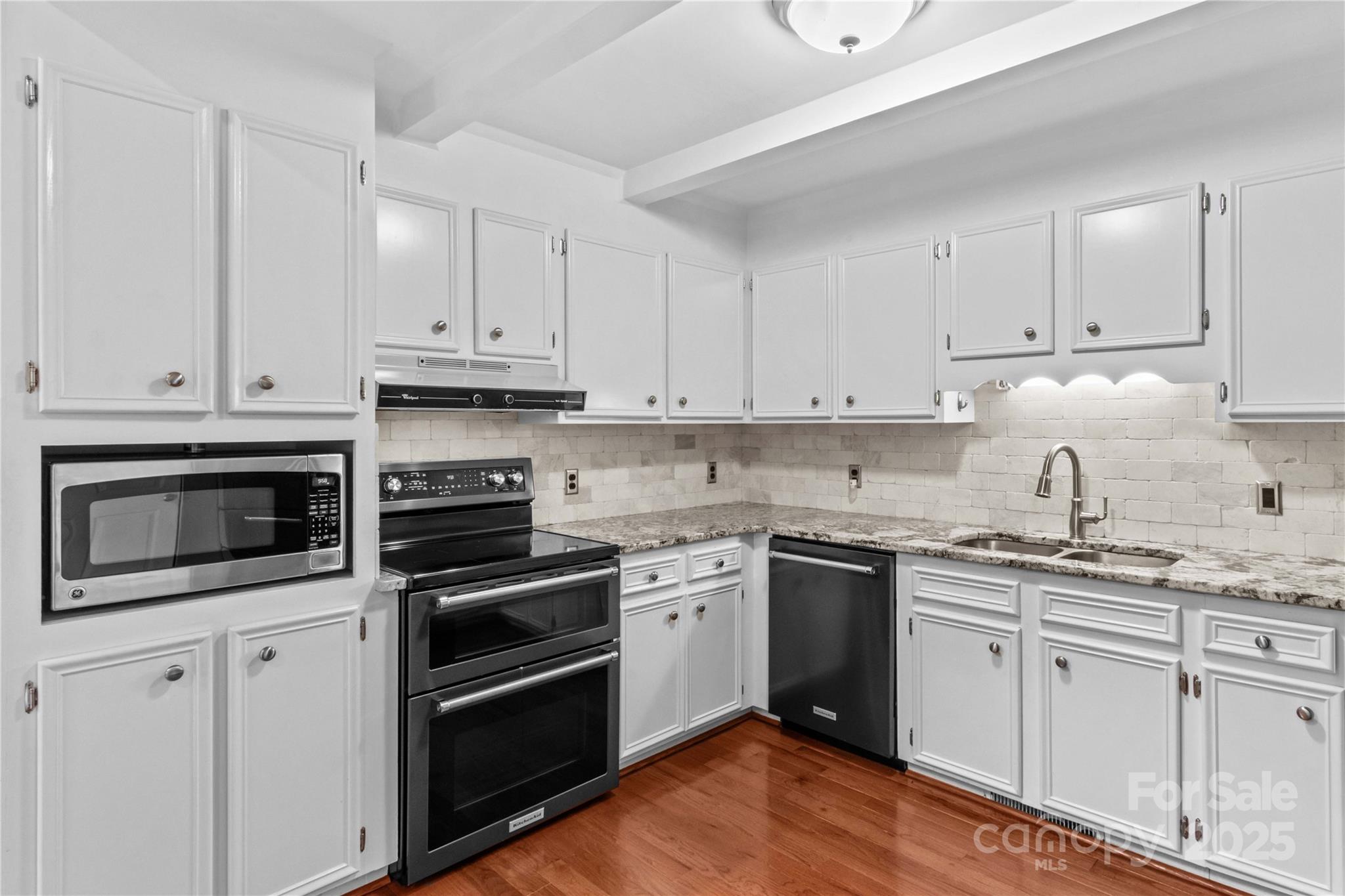 296 Hicks Creek Road Troutman, NC 28166 - Photo 14 of 48 a kitchen with cabinets stainless steel appliances and sink
