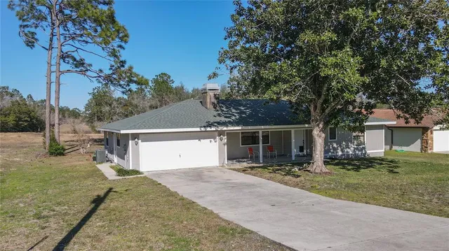 a front view of house with yard outdoor seating and barbeque oven