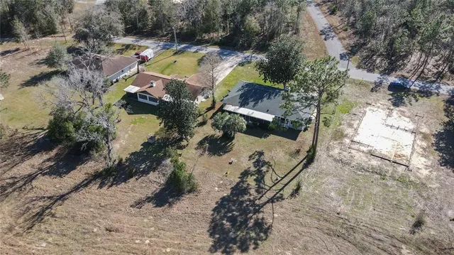 an aerial view of house with yard swimming pool and outdoor seating