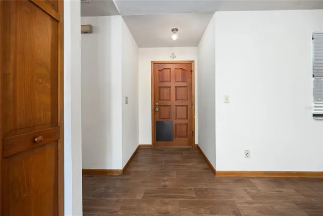 an empty room with wooden floor and closet