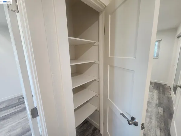 a view of walk in closet with empty racks