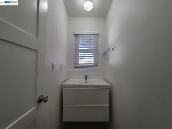 a bathroom with a sink and a window