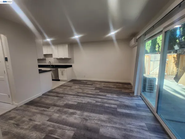 a view of a kitchen with a sink and wooden floor