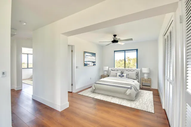 a bedroom with a large bed and a window