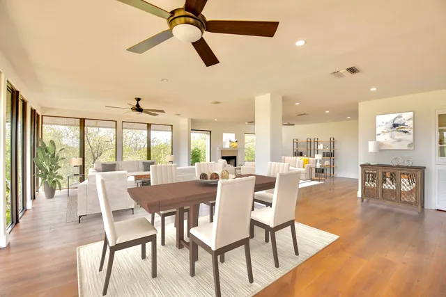 a living room with furniture and a large window with garden view