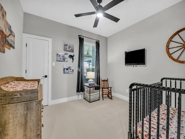 a bedroom with furniture and a flat screen tv