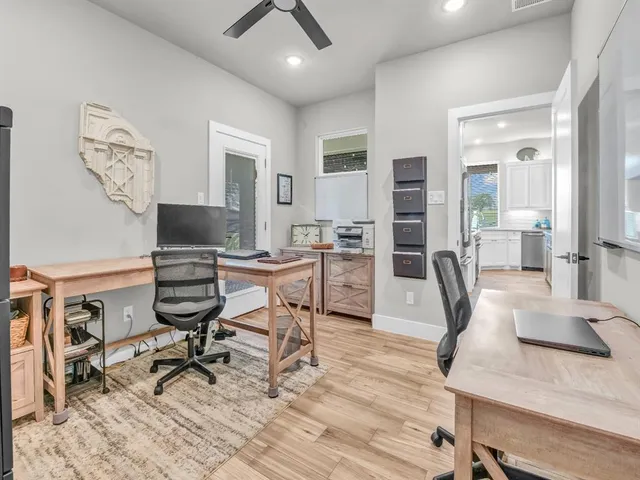 a view of a workspace with furniture and a potted plant