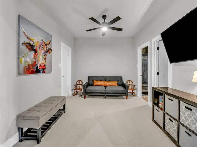 a view of a livingroom with furniture and a flat screen tv