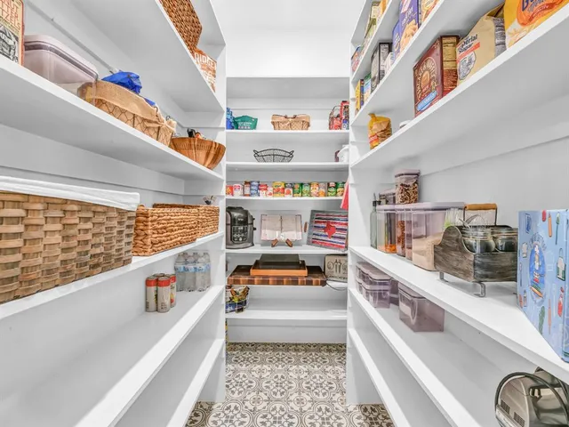 a utility room with stainless steel appliances toys and a large window
