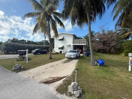 a view of a backyard with swimming pool