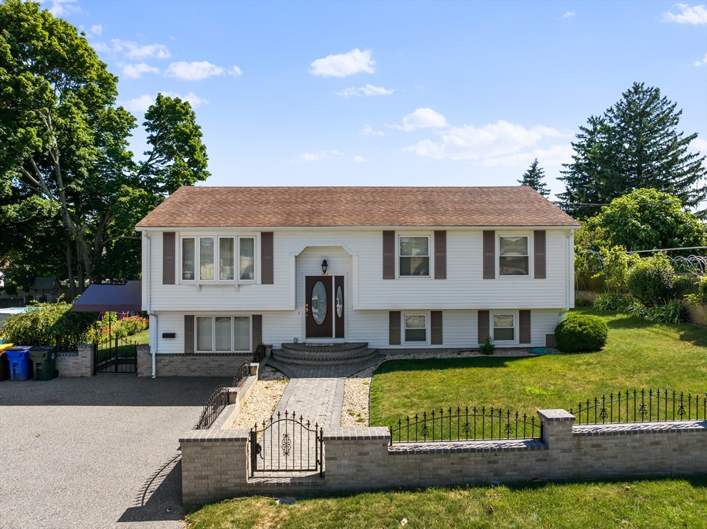 a front view of a house with a yard table and chairs