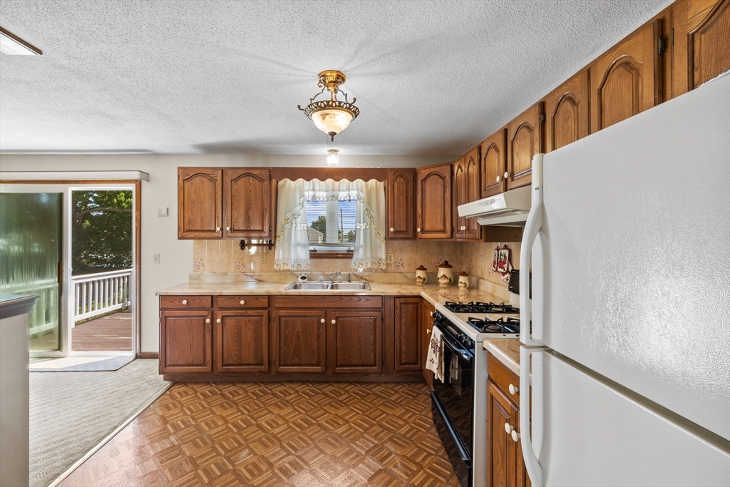 403 Aetna Street Fall River, MA 02721 - Photo 12 of 42 a kitchen with stainless steel appliances granite countertop a stove and a sink