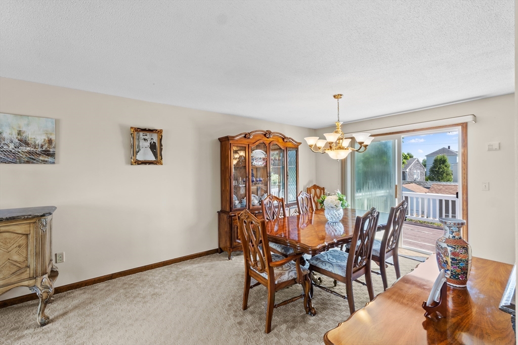403 Aetna Street Fall River, MA 02721 - Photo 18 of 42 a view of a dining room with furniture wooden floor and chandelier
