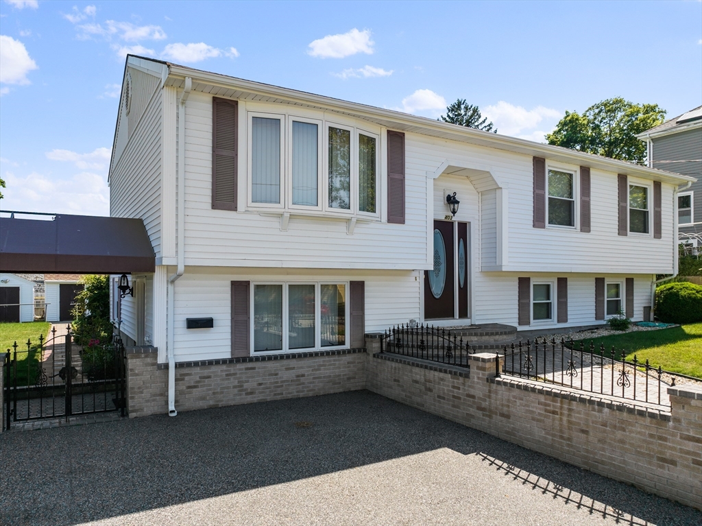 403 Aetna Street Fall River, MA 02721 - Photo 2 of 42 a view of a white house with large windows and a table and chairs