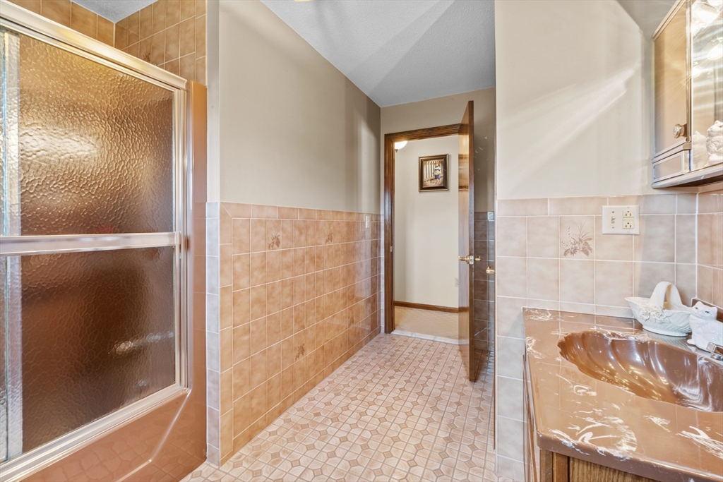 403 Aetna Street Fall River, MA 02721 - Photo 23 of 42 a bathroom with a tub and shower