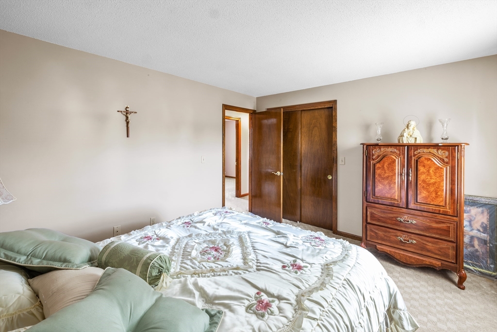 403 Aetna Street Fall River, MA 02721 - Photo 25 of 42 a bedroom with a bed and wooden floor