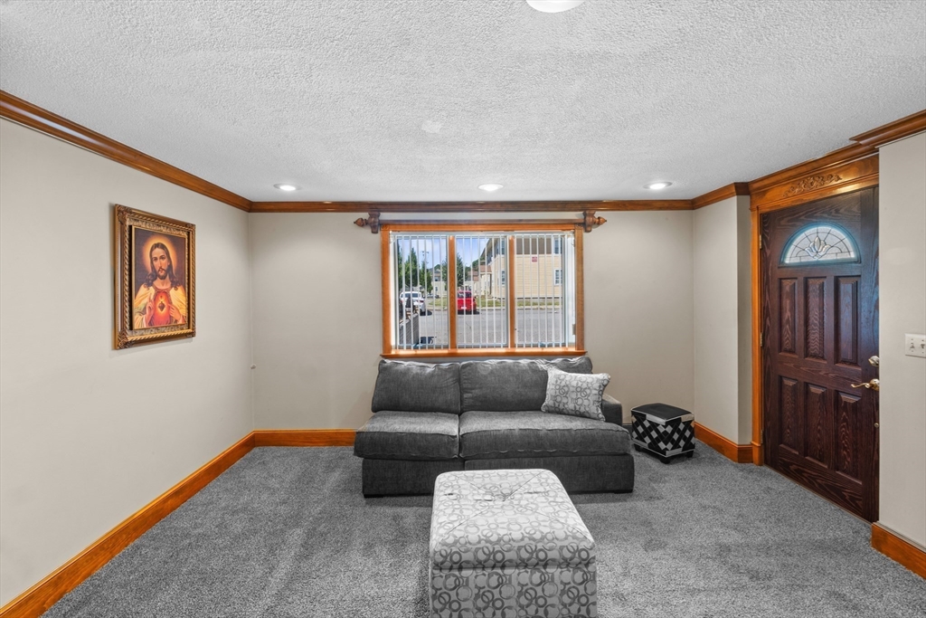 403 Aetna Street Fall River, MA 02721 - Photo 29 of 42 a living room with furniture and a window