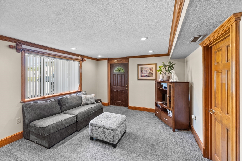 403 Aetna Street Fall River, MA 02721 - Photo 30 of 42 a living room with furniture and a window