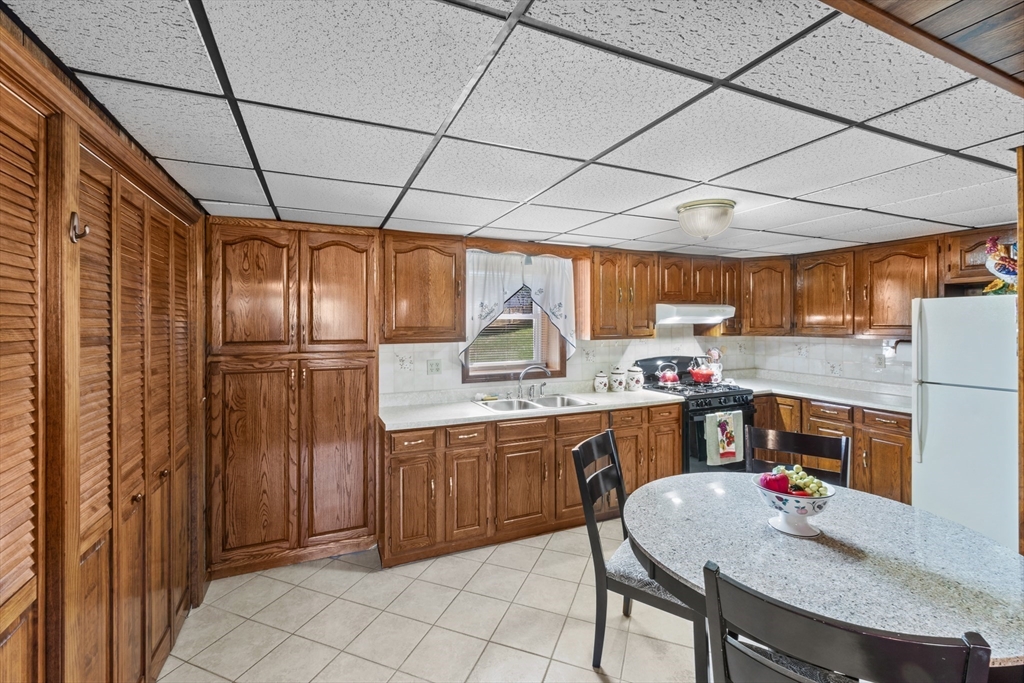 403 Aetna Street Fall River, MA 02721 - Photo 31 of 42 a kitchen with refrigerator and cabinets
