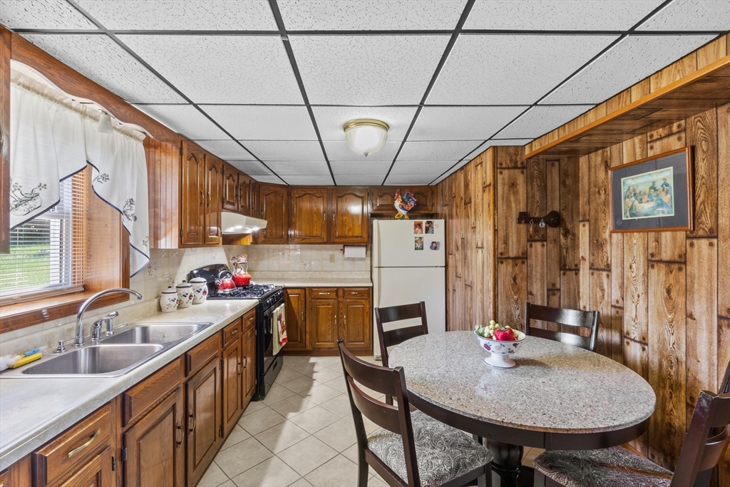 403 Aetna Street Fall River, MA 02721 - Photo 32 of 42 a kitchen with sink cabinets and refrigerator