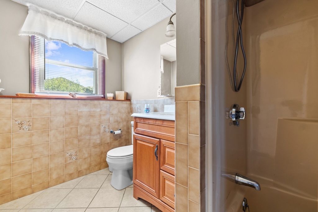 403 Aetna Street Fall River, MA 02721 - Photo 38 of 42 a bathroom with a granite countertop toilet and a sink