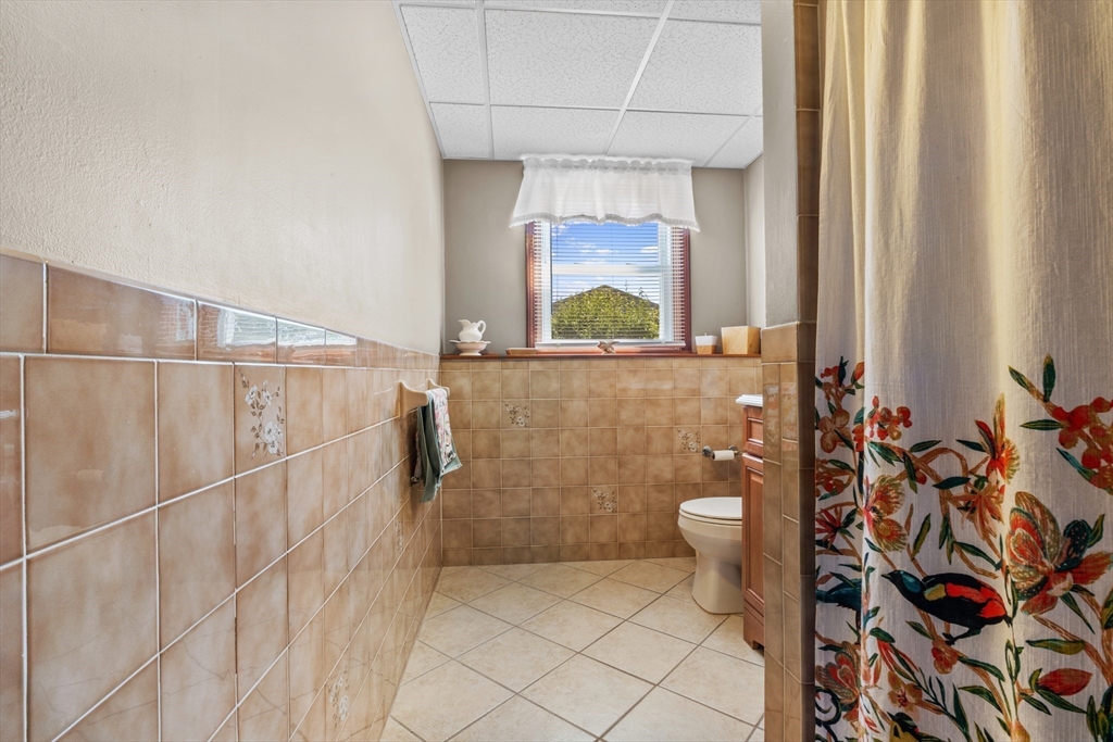 403 Aetna Street Fall River, MA 02721 - Photo 40 of 42 a bathroom with a toilet and a shower curtain