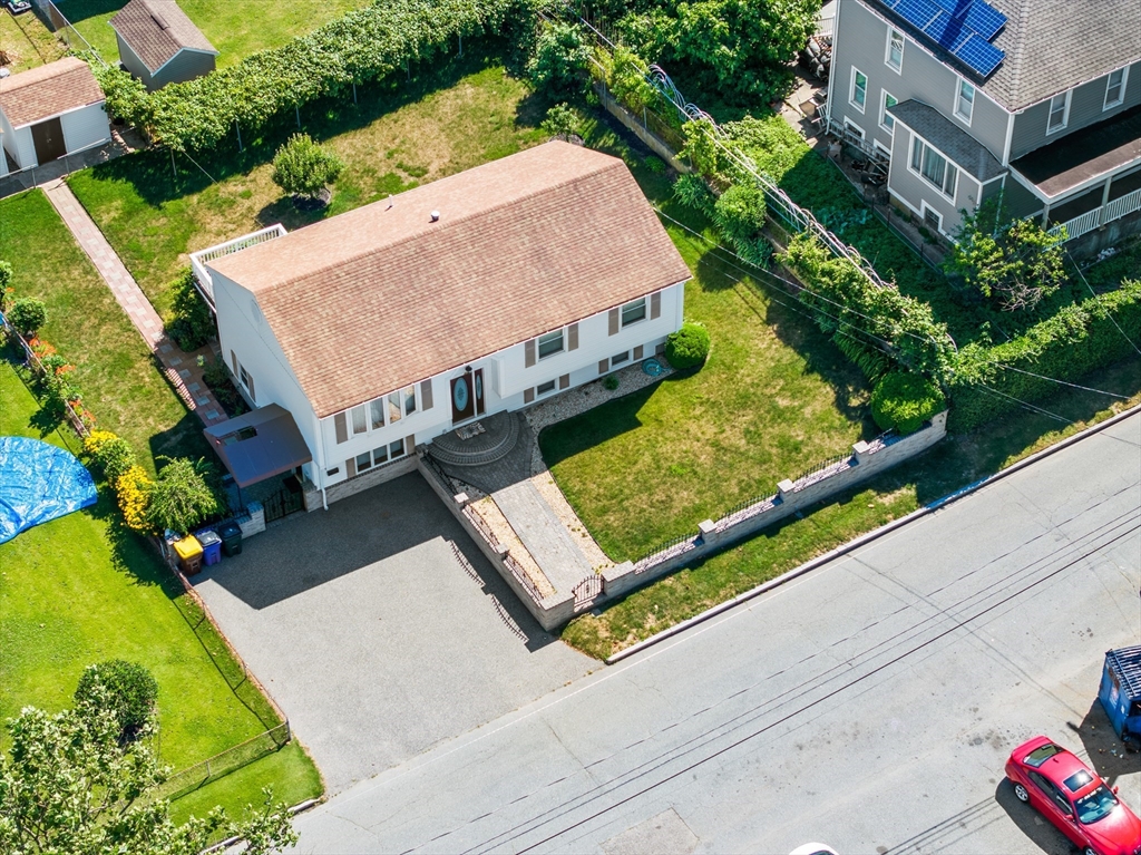 403 Aetna Street Fall River, MA 02721 - Photo 4 of 42 an aerial view of a house with a garden and large trees