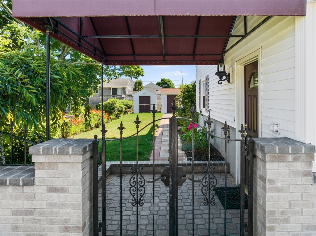 403 Aetna Street Fall River, MA 02721 - Photo 9 of 42 a view of a patio with table and chairs under an umbrella