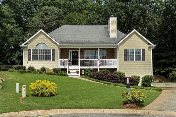 a front view of a house with a yard