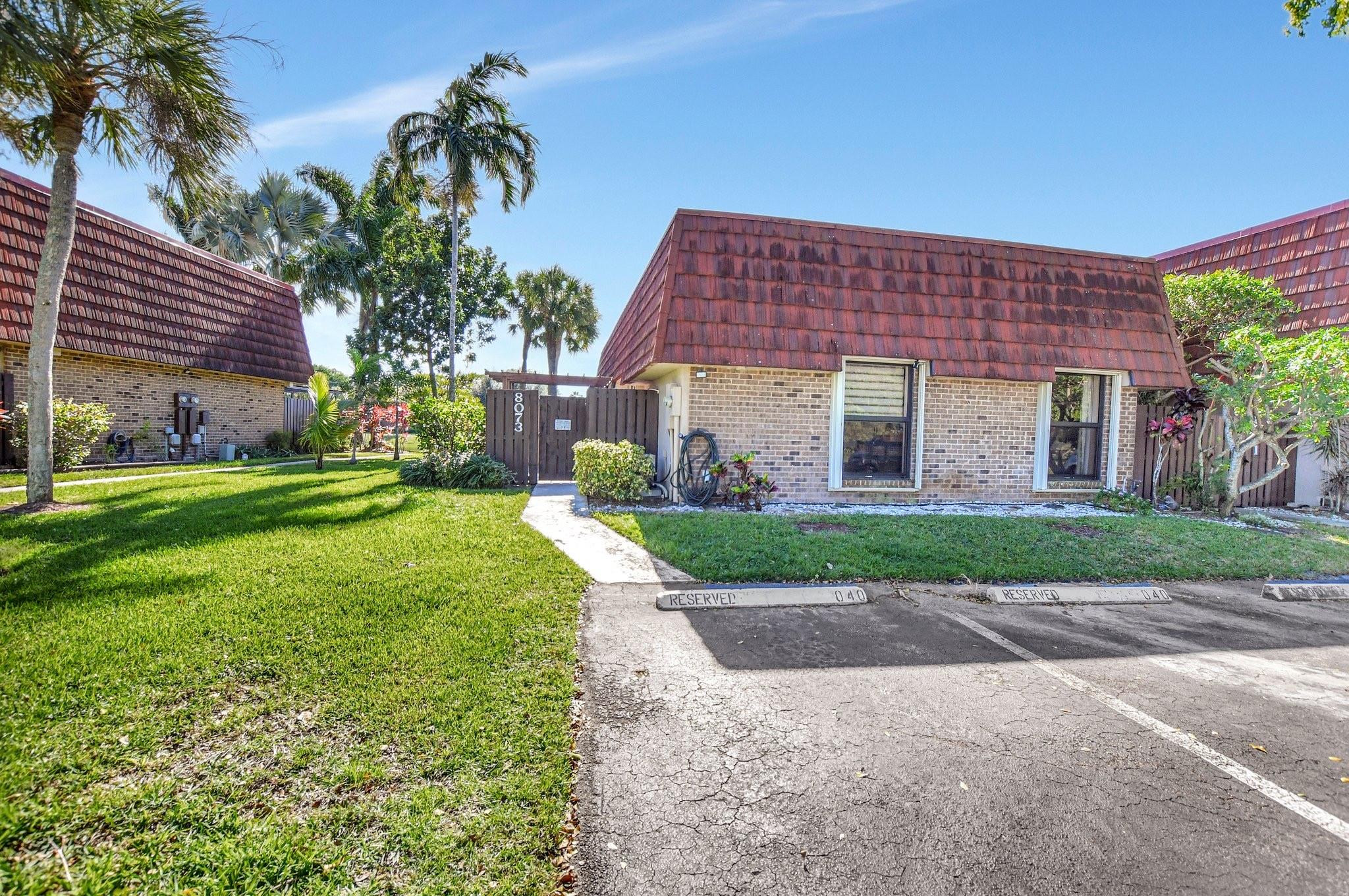 8073 Boca Rio Drive Boca Raton, FL 33433 - Photo 36 of 56 a front view of a house with a yard
