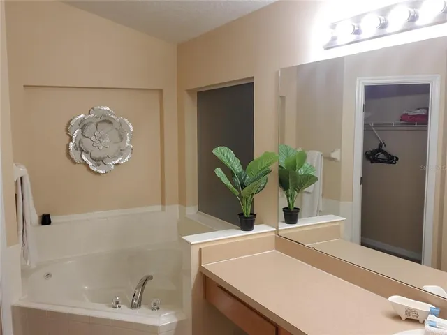 a bedroom with a bed and a lamp