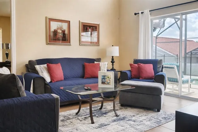 a living room with furniture or couch and a large window