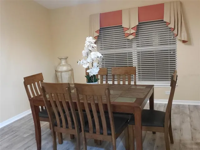 a living room with furniture a table and chairs