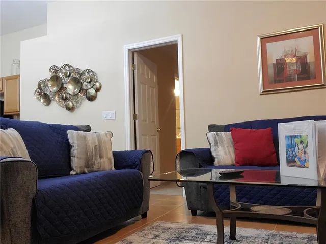 a living room with furniture and a potted plant