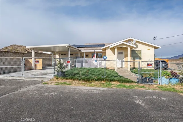 a front view of house with a yard and potted plants