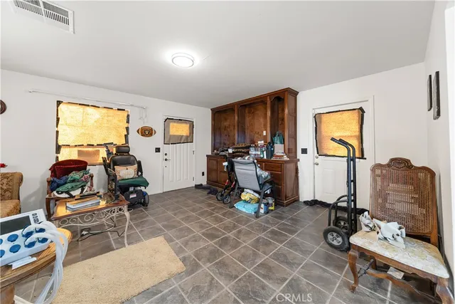 a living room with furniture a air conditioner vent and a window
