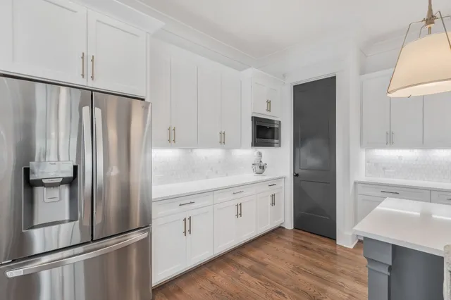 a kitchen with stainless steel appliances a refrigerator sink and microwave