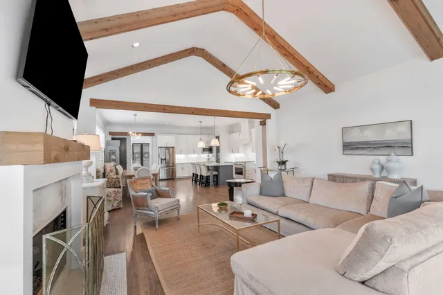 a living room with furniture and a floor to ceiling window