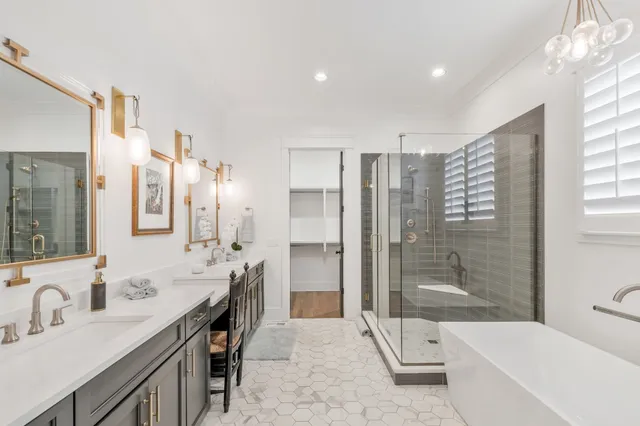 a spacious bathroom with a double vanity sink shower and a mirror