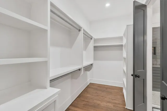 a bathroom with a sink a toilet a mirror and shower