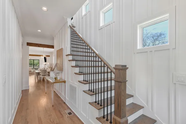 a view of entryway and hall with wooden floor