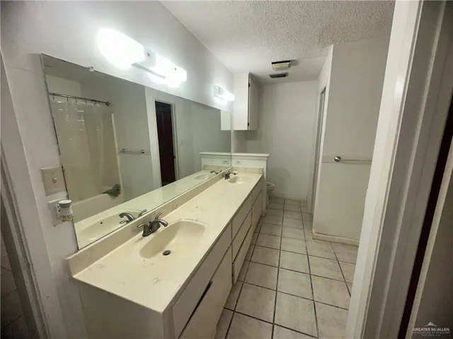a bathroom with a sink mirror and shower