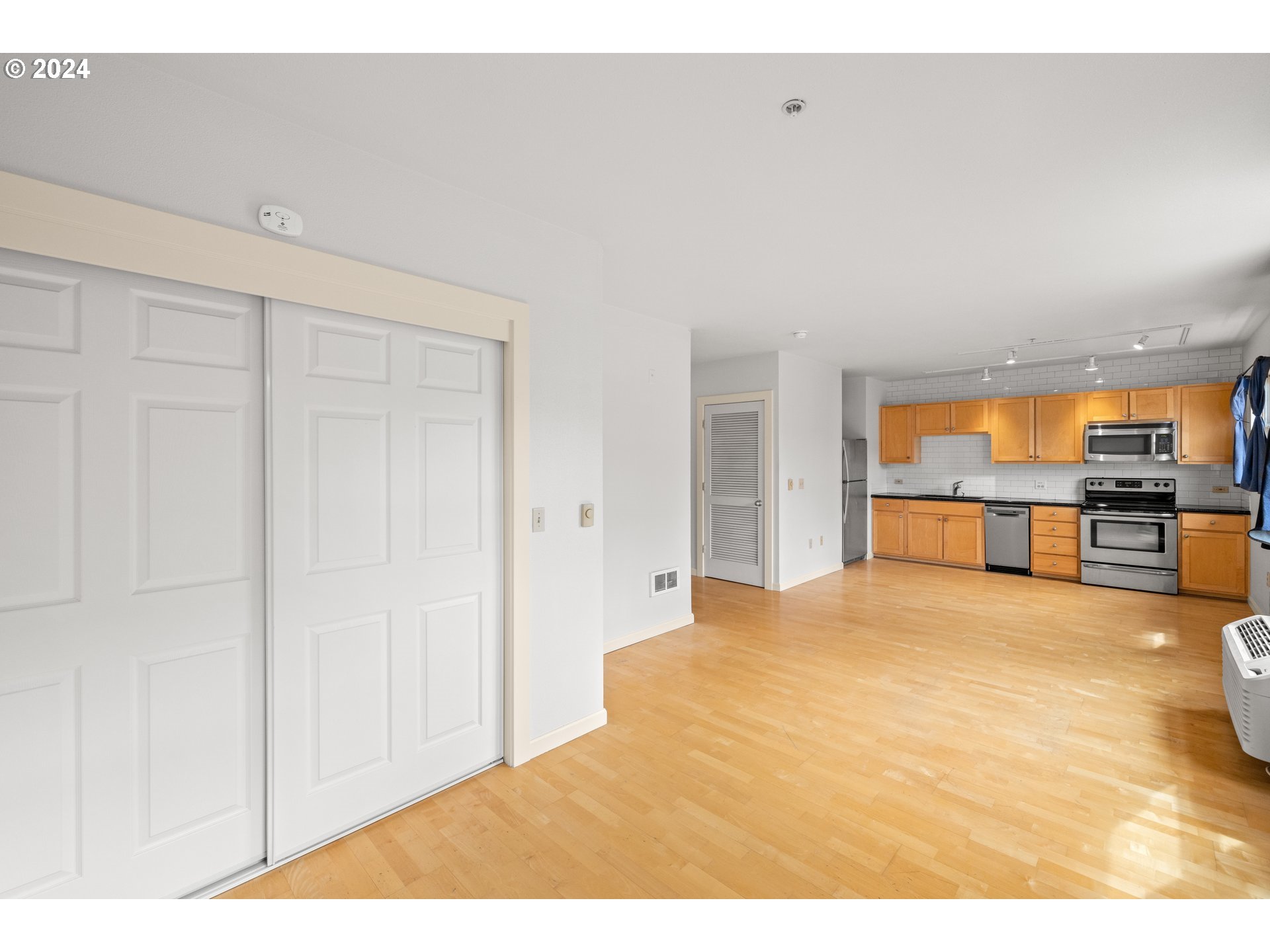 1134 Southwest Jefferson Street, Unit 508 Portland, OR 97201 - Photo 14 of 29 a view of an empty room with kitchen and a sink