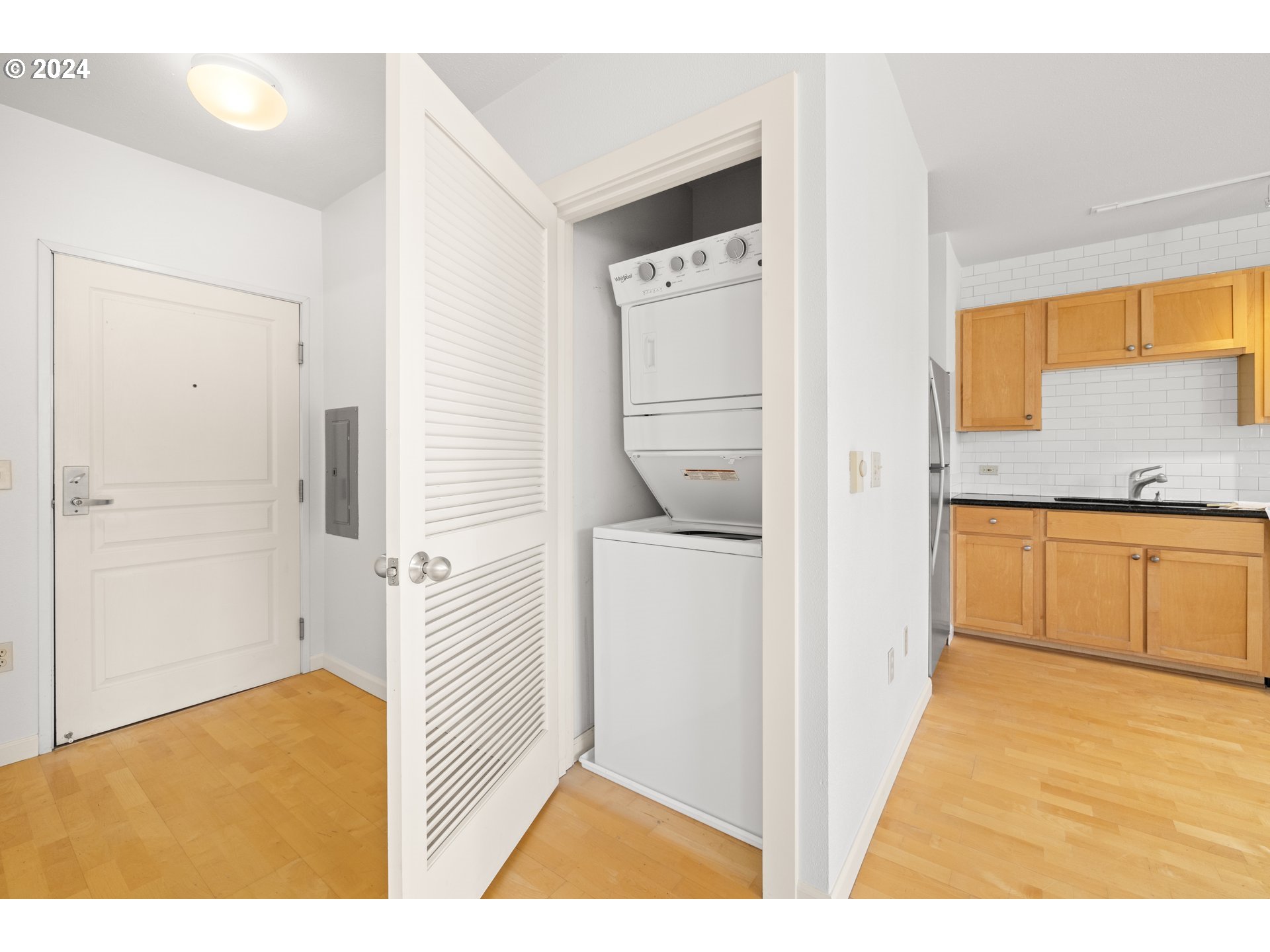 1134 Southwest Jefferson Street, Unit 508 Portland, OR 97201 - Photo 17 of 29 a view of a kitchen with white cabinets and a stove