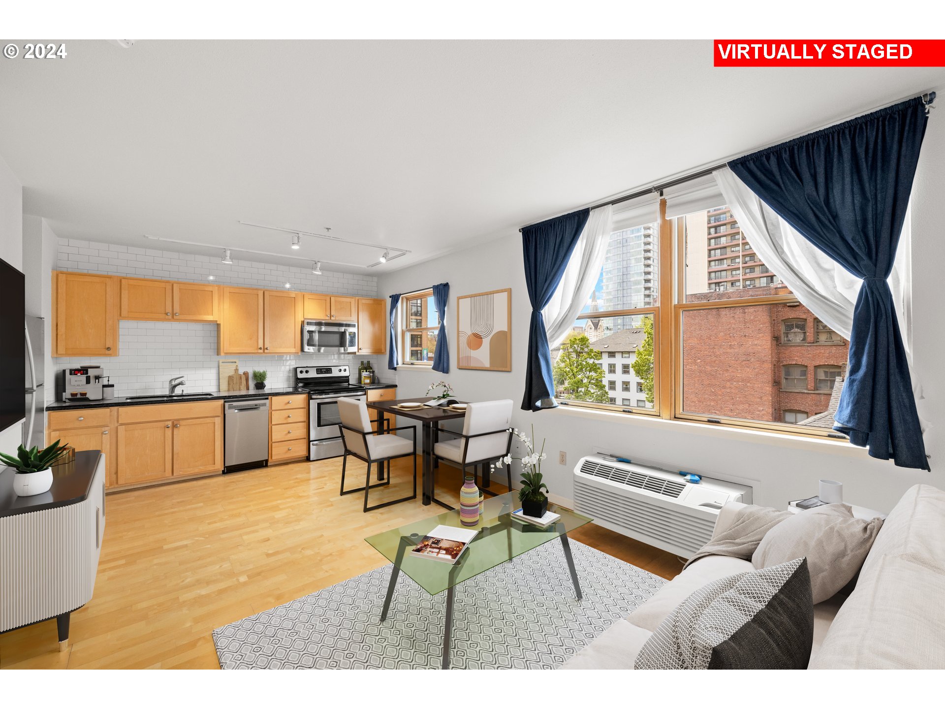 1134 Southwest Jefferson Street, Unit 508 Portland, OR 97201 - Photo 10 of 29 a living room with furniture and a large window