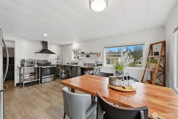 a kitchen with stainless steel appliances kitchen island granite countertop a sink and cabinets